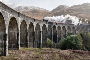 include travel and transport information in guest welcome packs, steam train on a bridge in Scotland