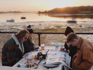 two couples eating and drink at a table in st andrews